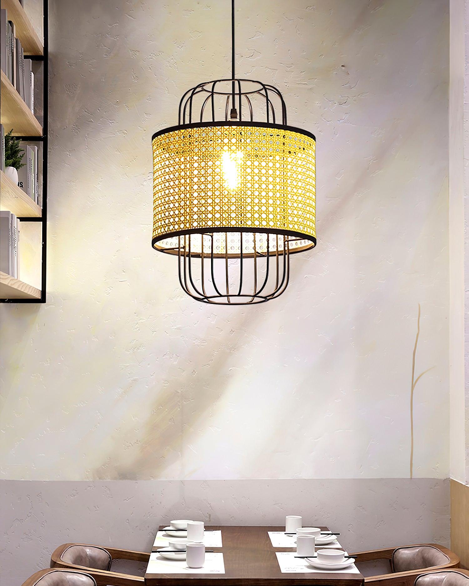Black cage and rattan pendant above a small wooden dining table beside shelving