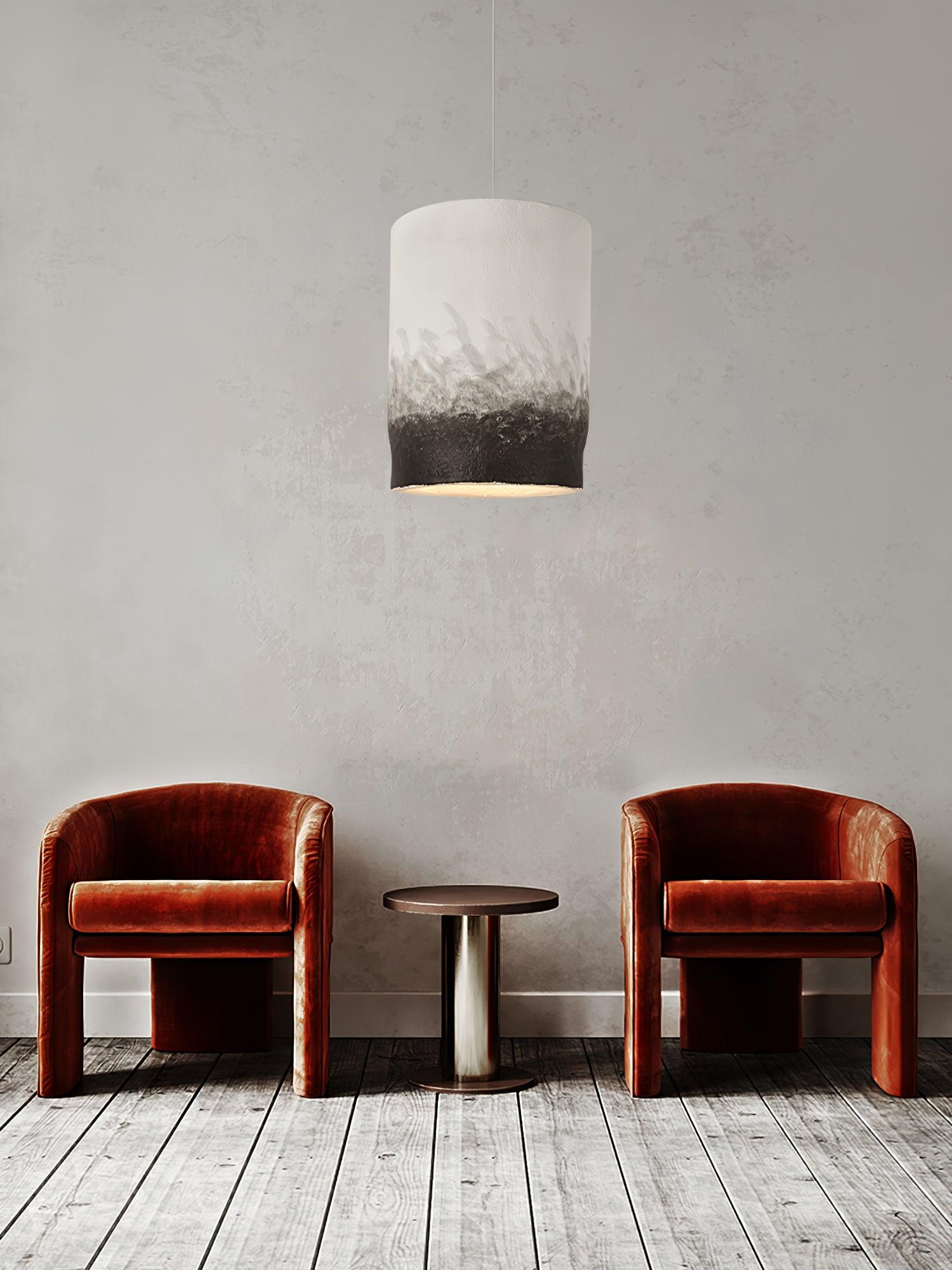 Grey and black pendant above two reddish chairs