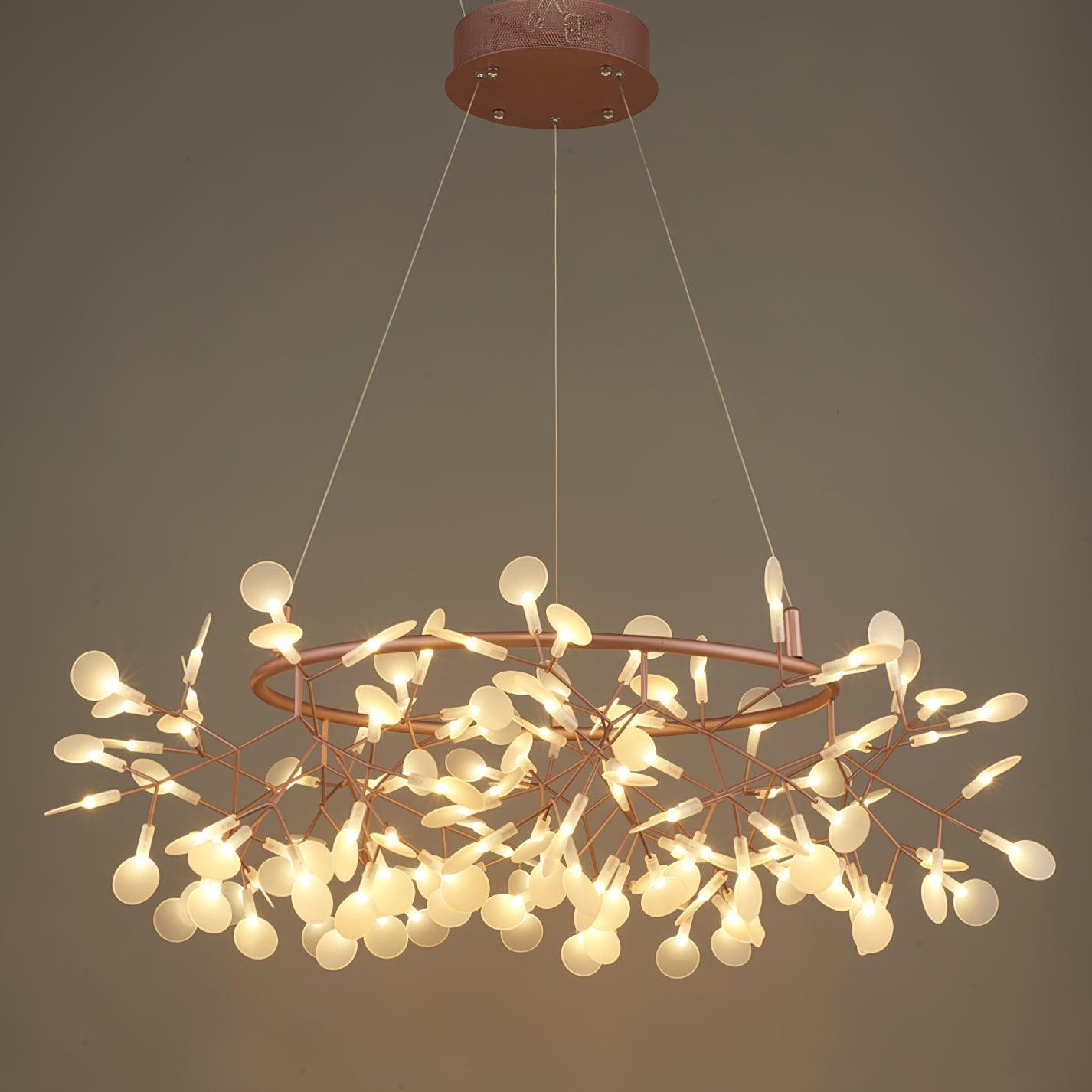 Rose-copper leaf ring chandelier lit against a brown backdrop, with a vented round canopy and three lines