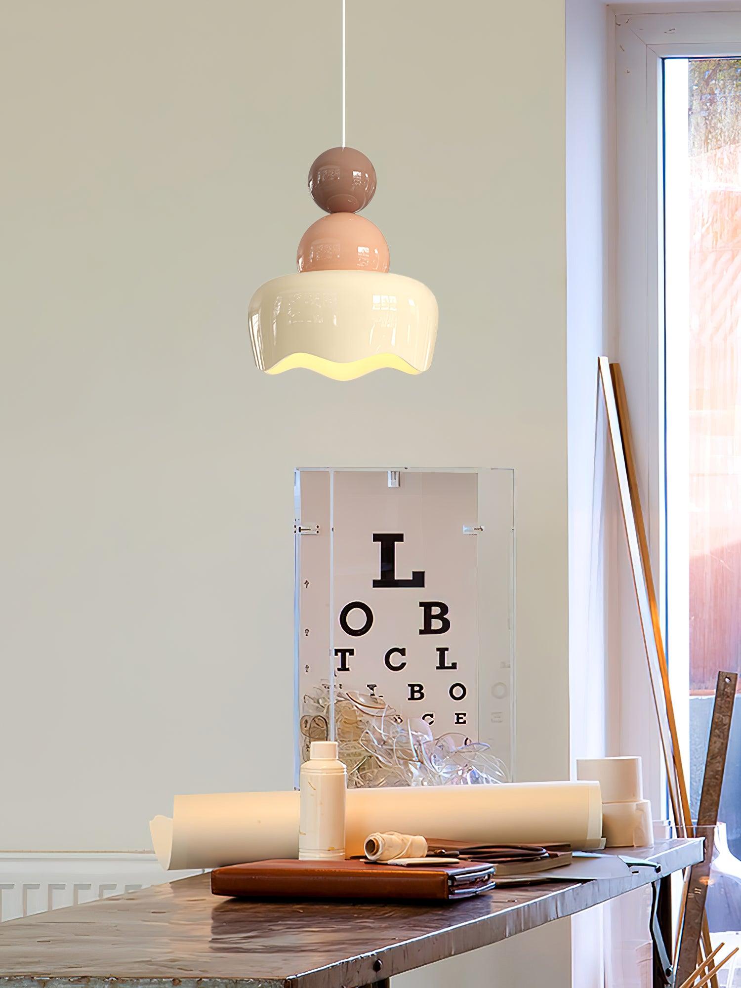 Pink-and-cream pendant over a desk