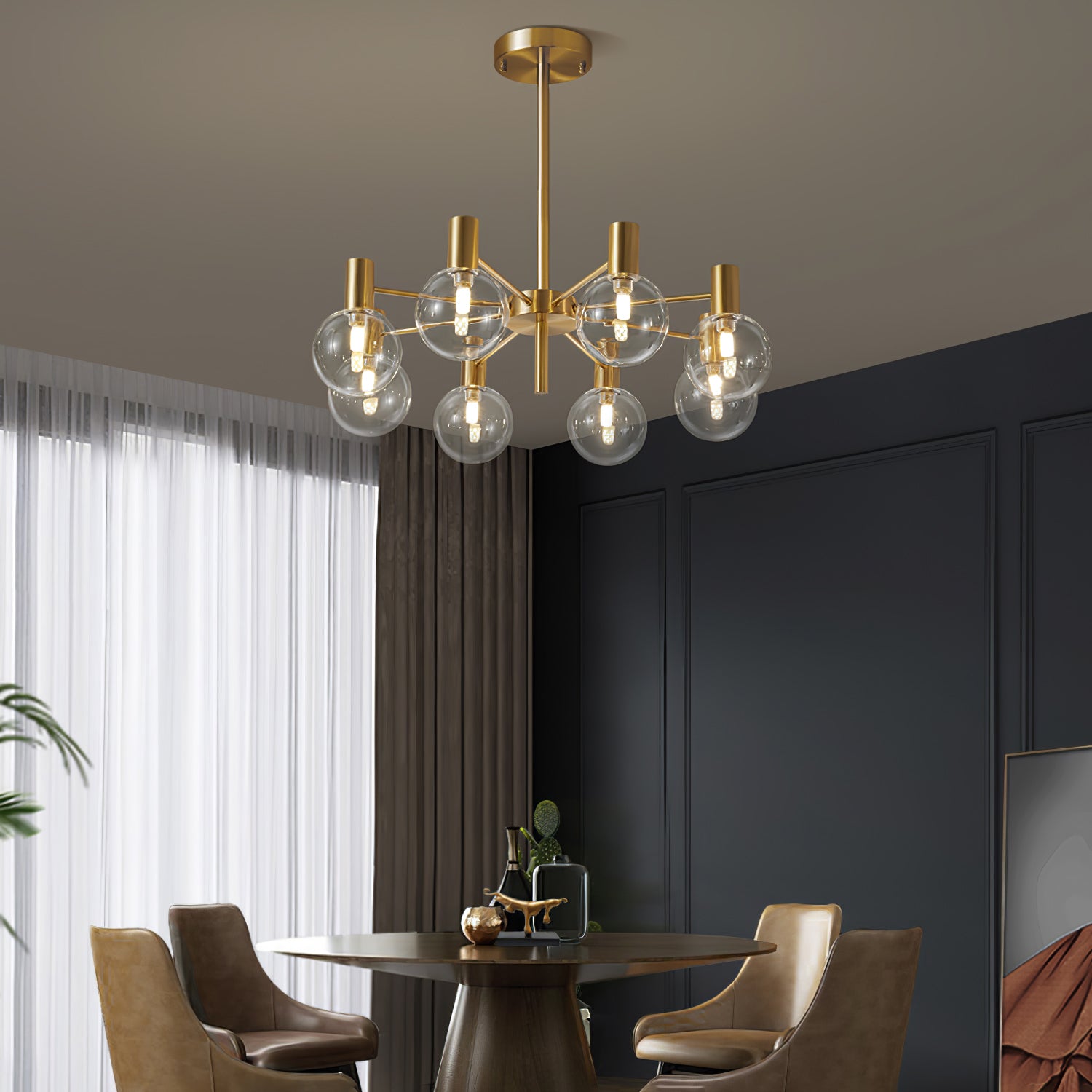 Eight lit clear globes on a gold-tone chandelier above a dark round table and tan chairs, beside tall white sheers.