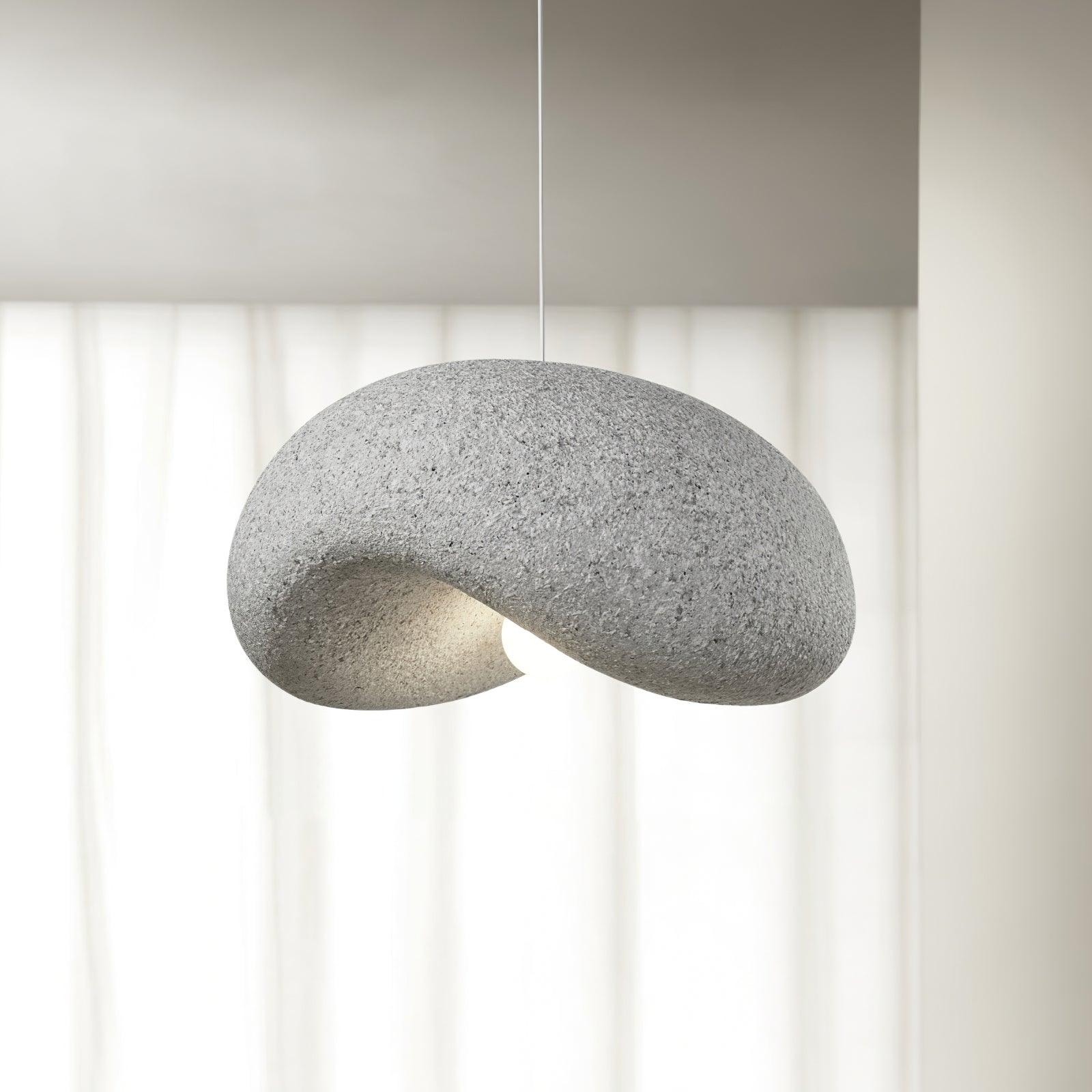 Gray organic pendant beside a window