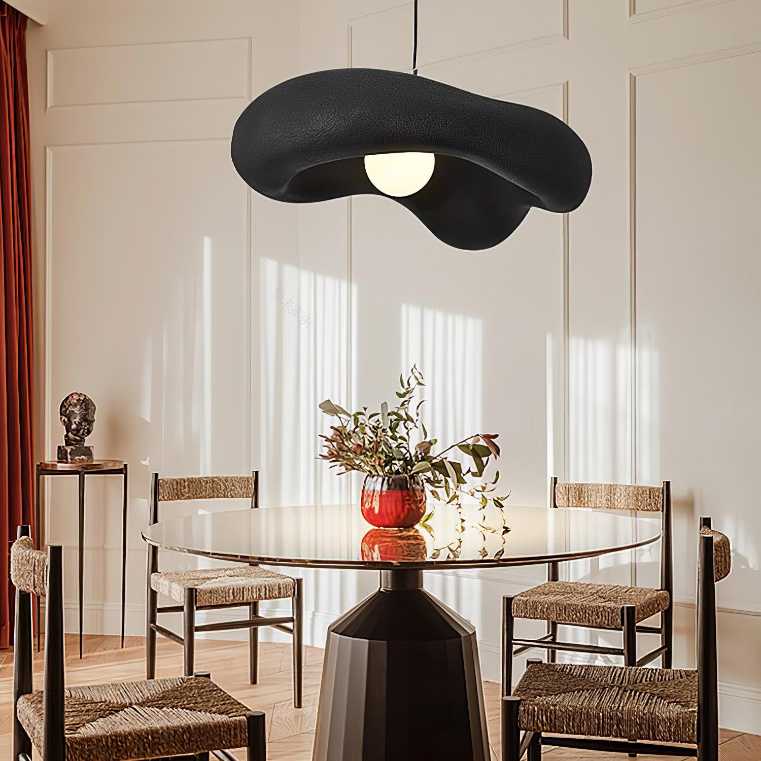 Black pendant above an indoor flower arrangement