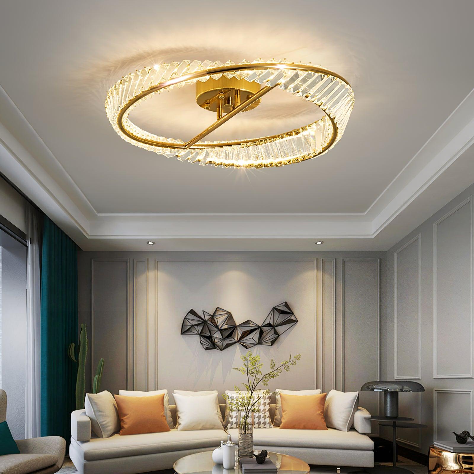 Illuminated glass ring ceiling light above a white sofa with orange cushions and geometric wall art