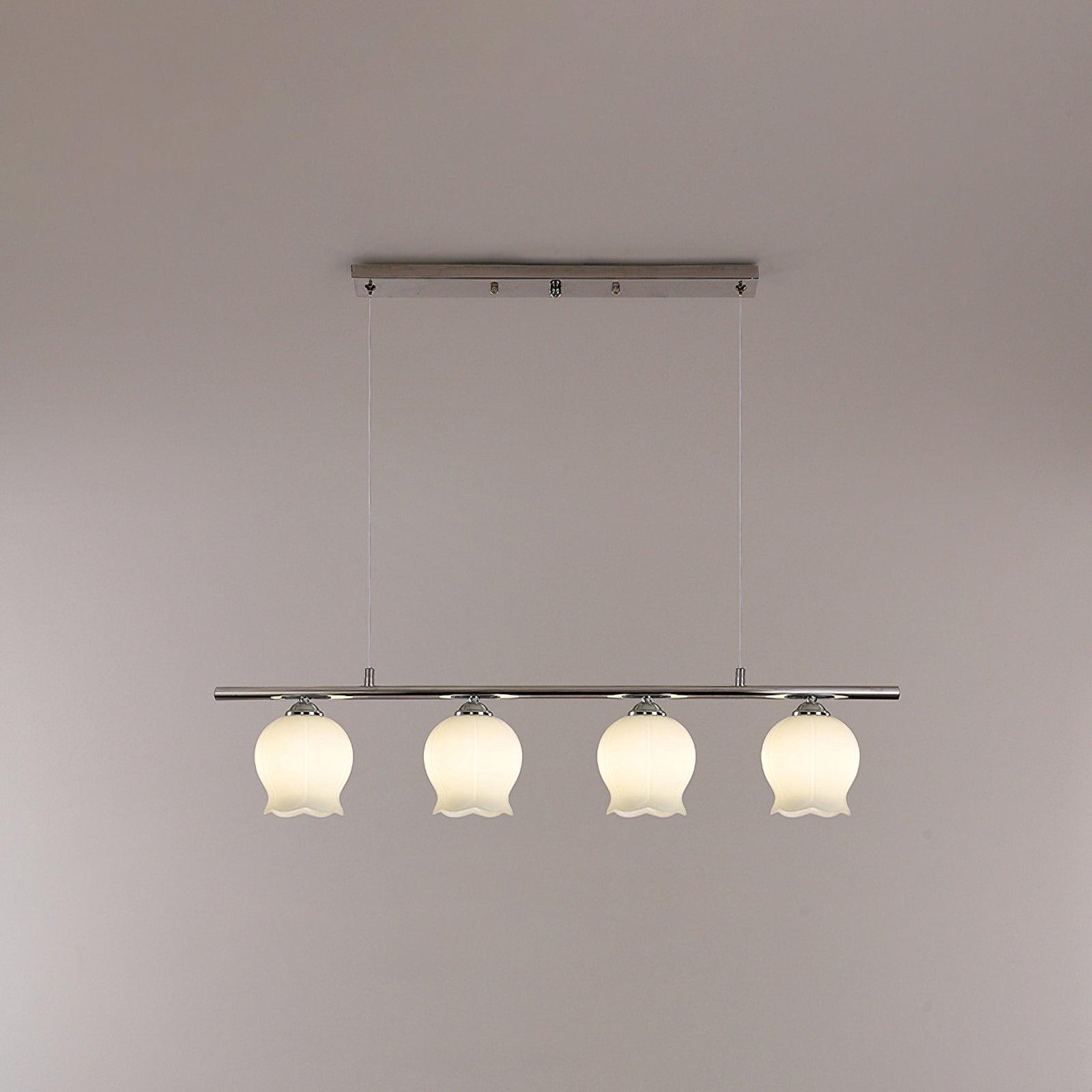 Illuminated four-shade linear chrome pendant with white bellflower glass