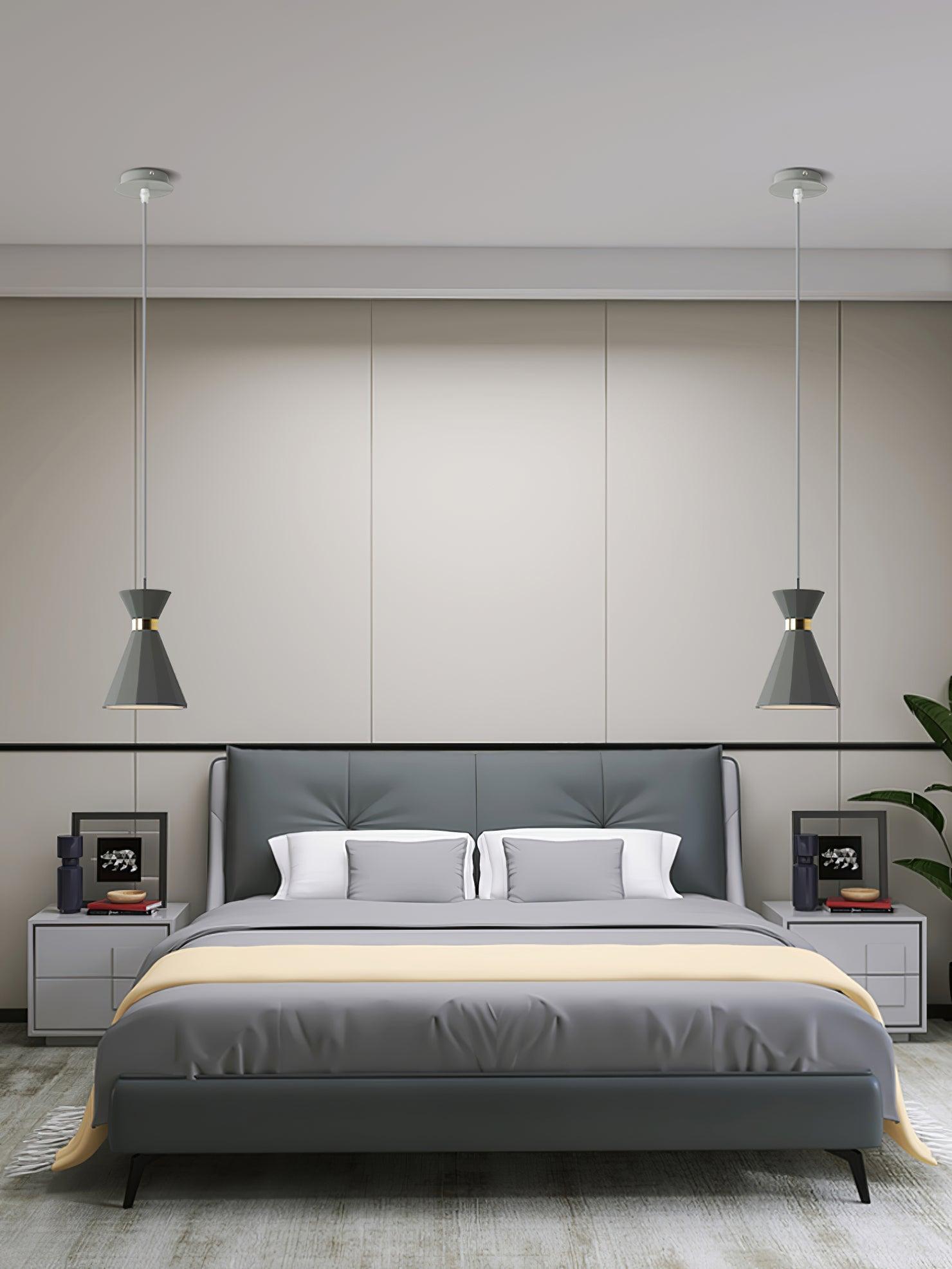 Two pendant lights with separate ceiling canopies beside a bed