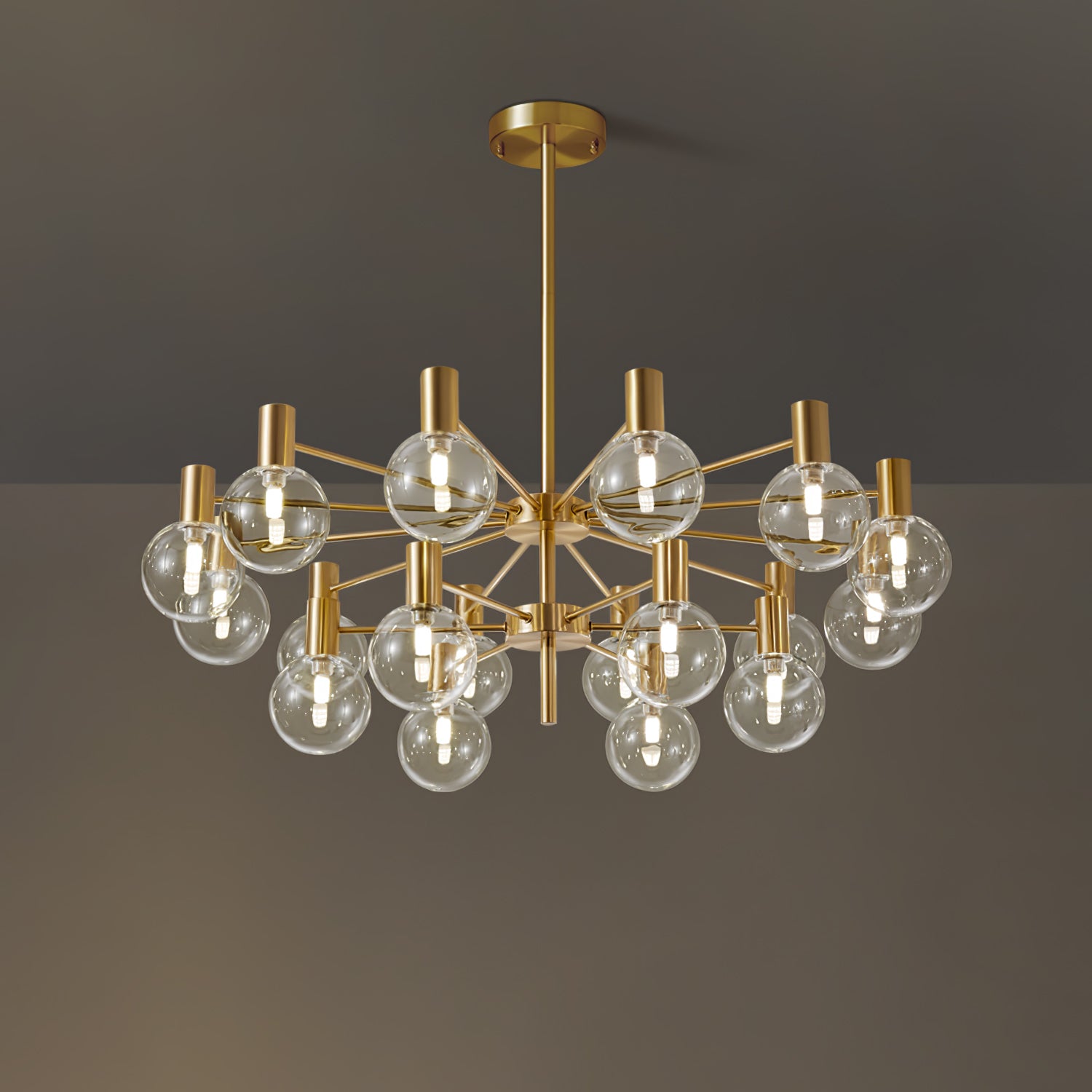 Lit two-tier clear-globe chandelier with gold-tone arms, a full ceiling rod and round canopy on a brown-grey background.