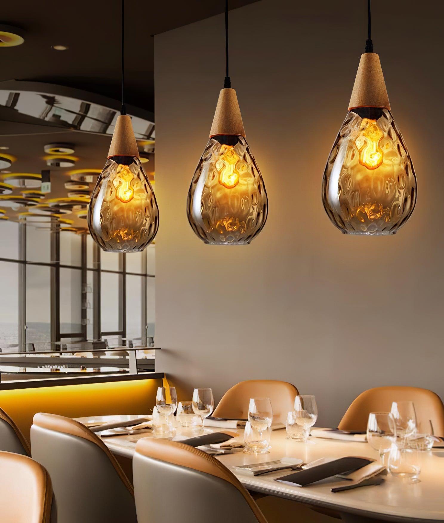 Separate Besnier pendants above a restaurant table