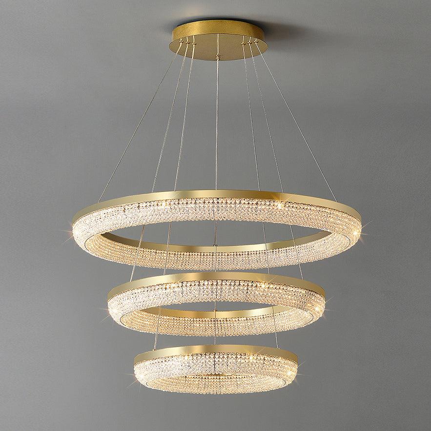 Complete three-tier gold crystal chandelier with descending circular rings and round ceiling canopy