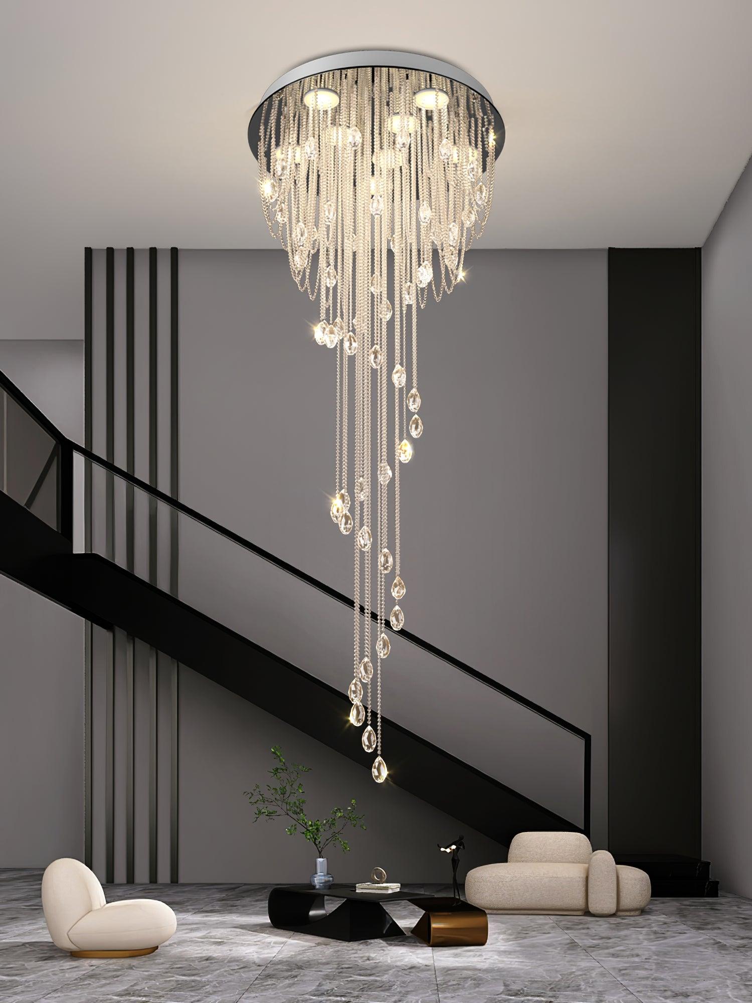 Bright crystal spiral in a gray double-height lounge with black stairs, rounded white seats and low dark tables