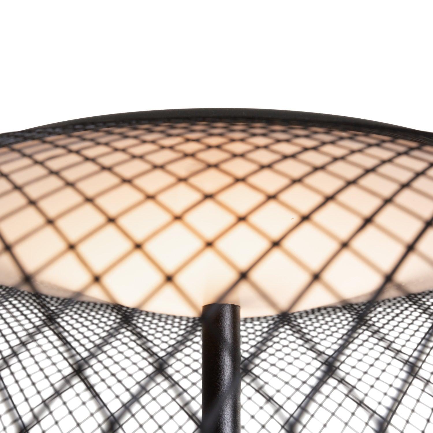 View through black mesh toward the glowing circular light element above the central stem