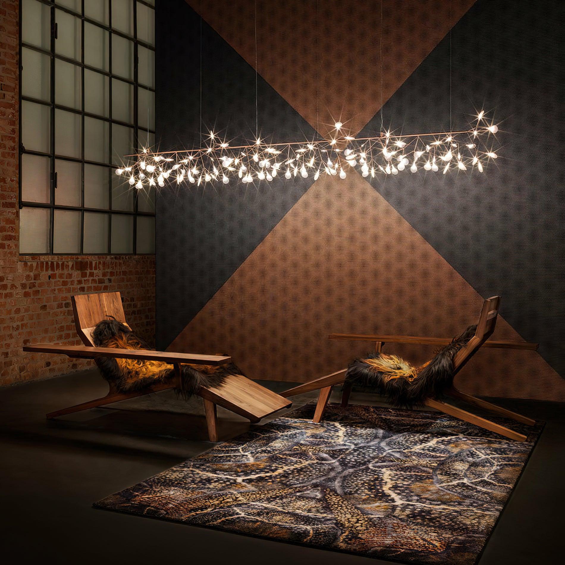 Long illuminated petal installation above wooden lounge chairs, brick and glazed wall, and large geometric wall pattern
