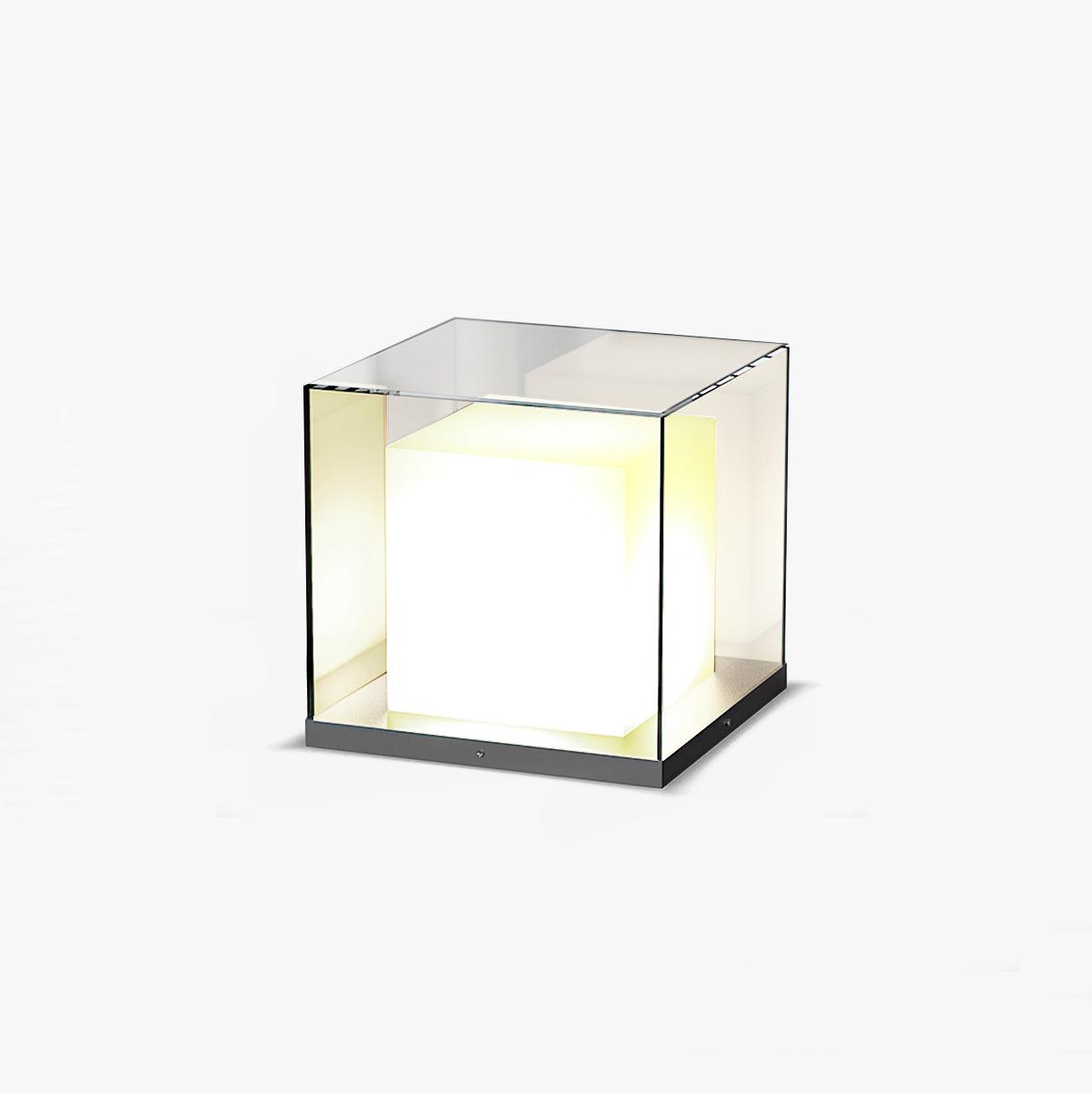 Wide view of an illuminated white cube inside a clear square enclosure with slim dark edges and a dark base
