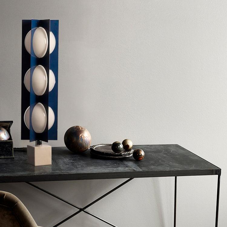 Cascade Tower on a dark console beside decorative spheres and a tray