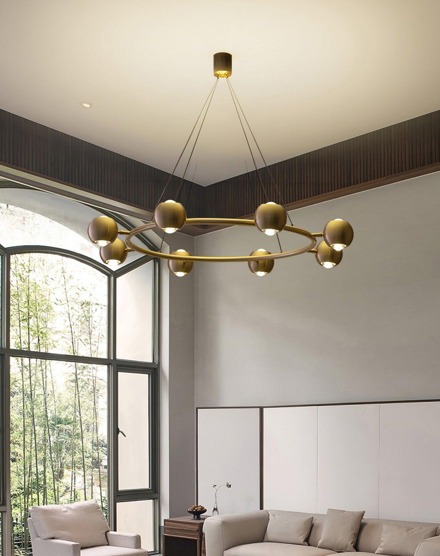Brass spherical-head chandelier near an arched window