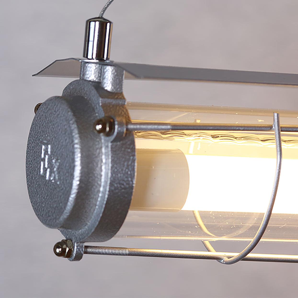 Close view of the Artisan Glass silver-tone end cap, fasteners, clear glass edge and suspension fitting