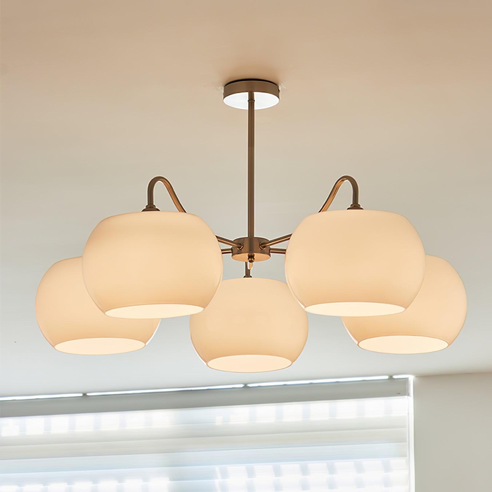 Persimmon chandelier with white glass shades and curved nickel-tone arms