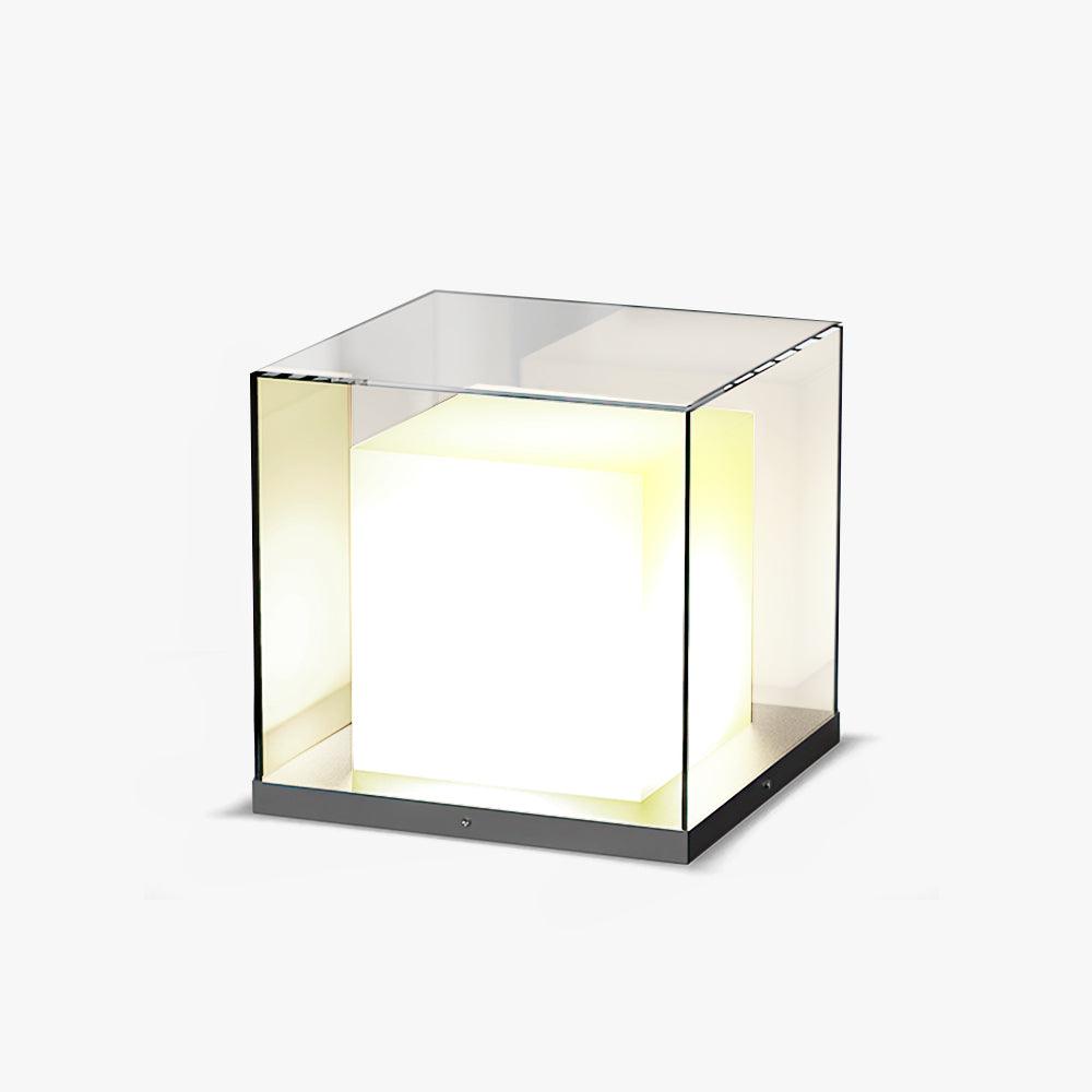 Distant view of a lit white cube inside a clear glass box with a plain top and dark grey base on white