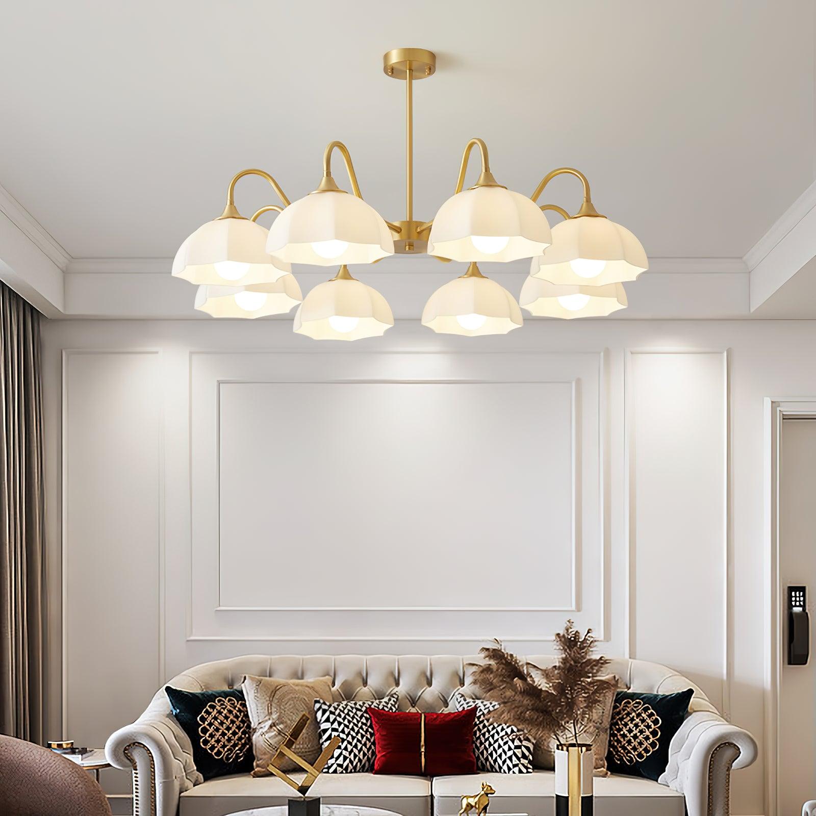 Wide glass-bowl chandelier above sofa