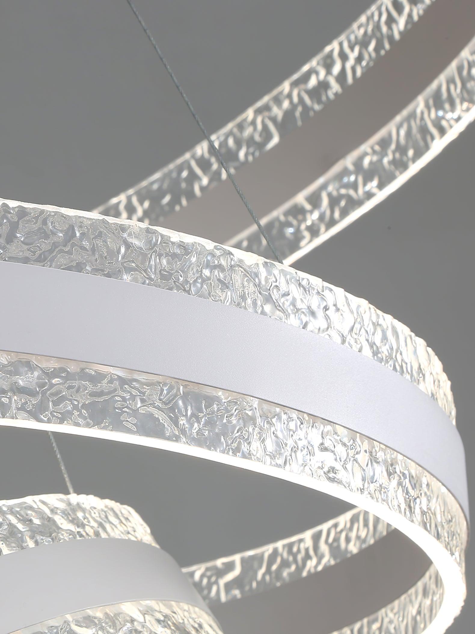 Extreme close-up of crinkled clear-looking ring edges around a pale centre band, with a suspension wire visible