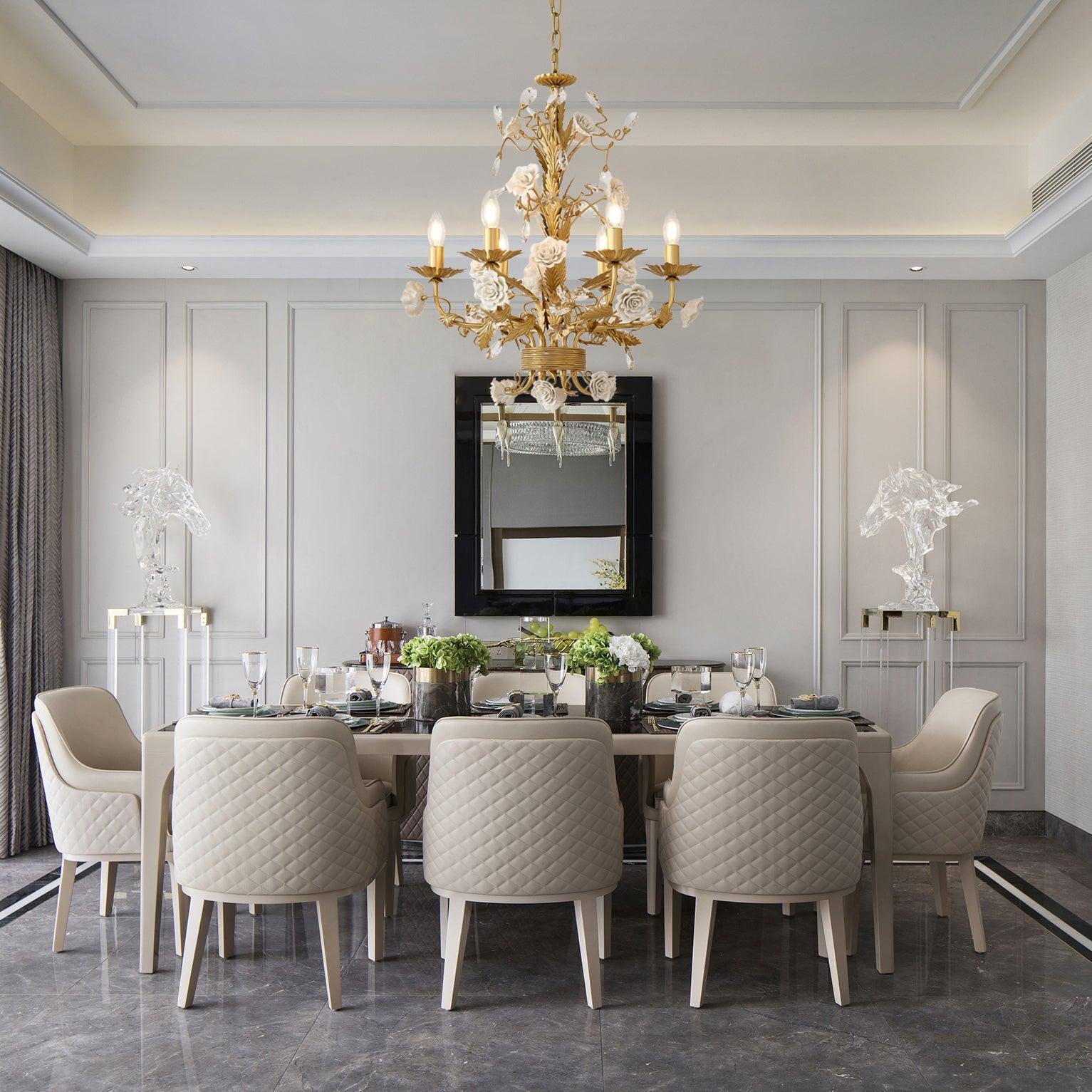 White Rose chandelier above a set dining table and quilted chairs, with flowers, black-framed mirror and glass horse sculptures