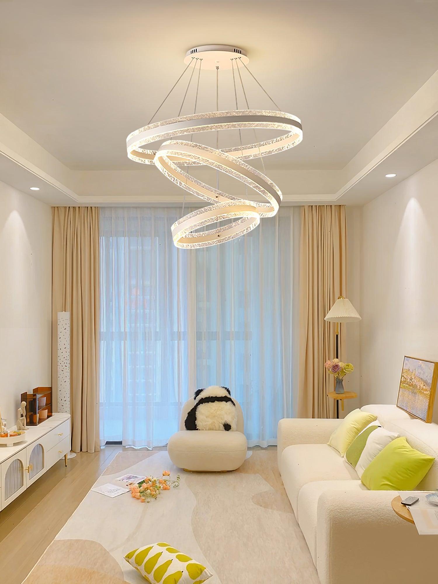 Three textured rings with a tilted middle ring above a white sofa with green cushions and a panda-like chair