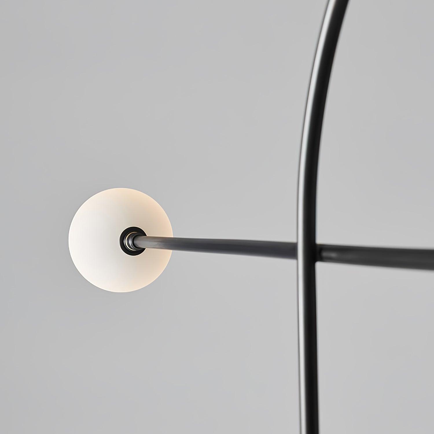 Close rear view of the white globe and dark collar joining Arcane Orb’s horizontal arm across the loop frame