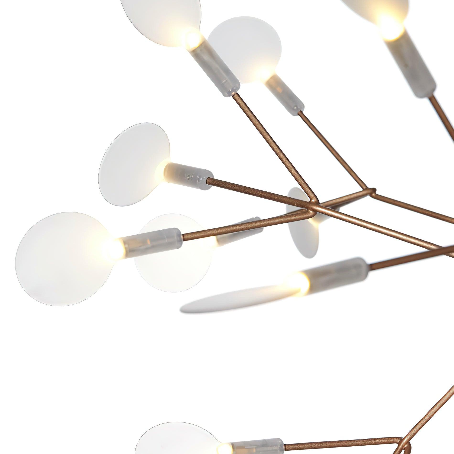 Close-up of warm-metal branching joints and rounded acrylic petal discs with glowing bases against white