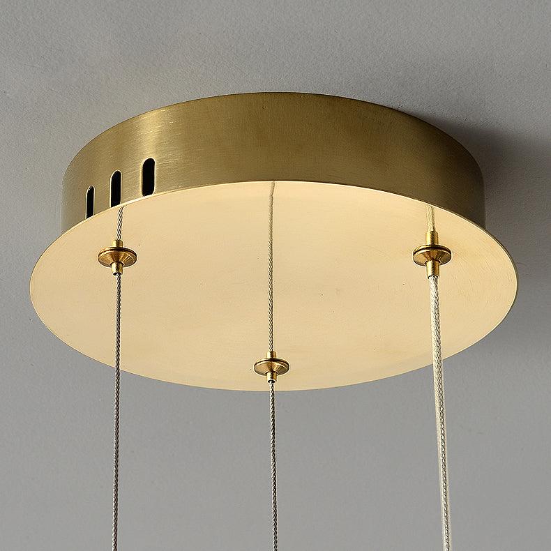 Underside of round gold-tone ceiling canopy with ventilation slots and fine suspension cables