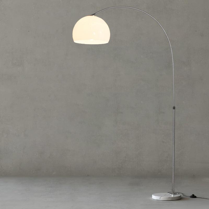 Full lit white dome arc lamp on grey background with round marble base and cable switch on the floor