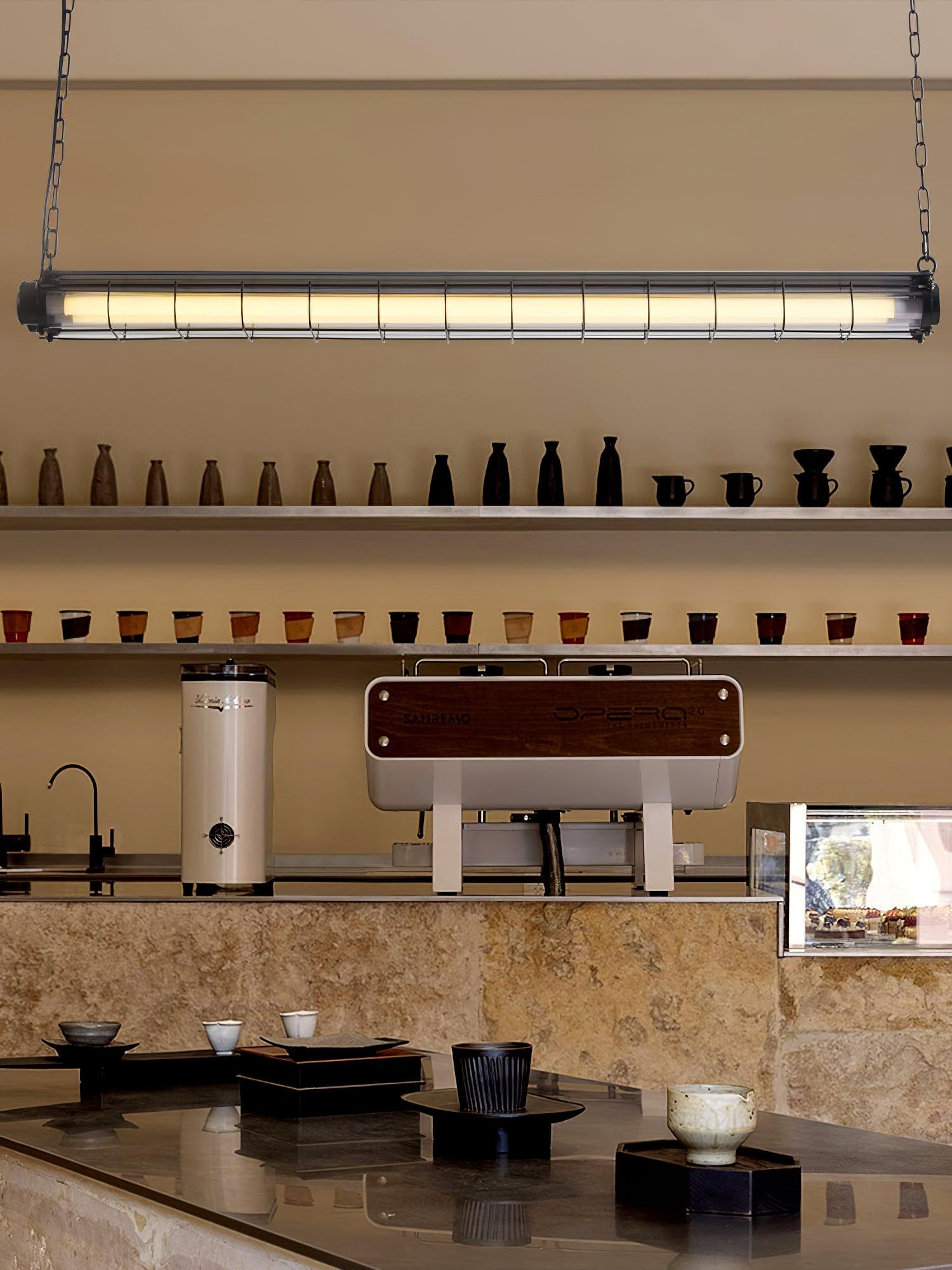 Artisan Glass linear chandelier above a coffee counter and neatly arranged wall shelves