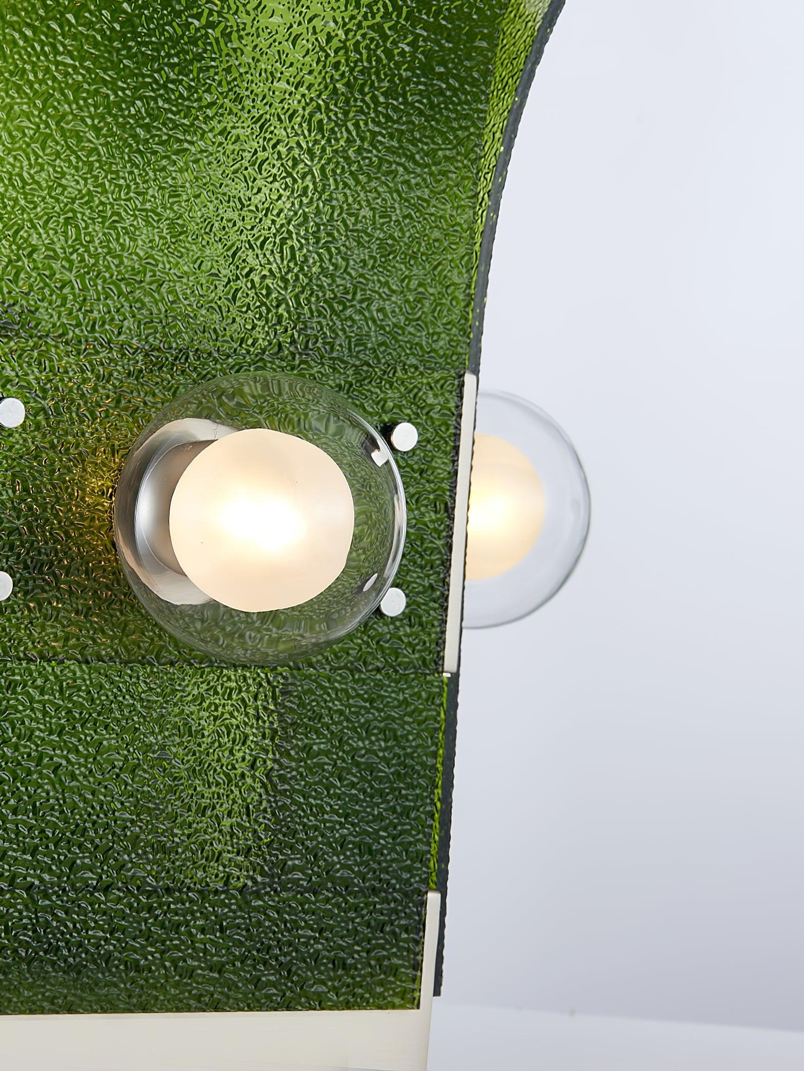 Close-up of glowing white round light within clear circular surround on textured Green panel, with side light and metal fasteners