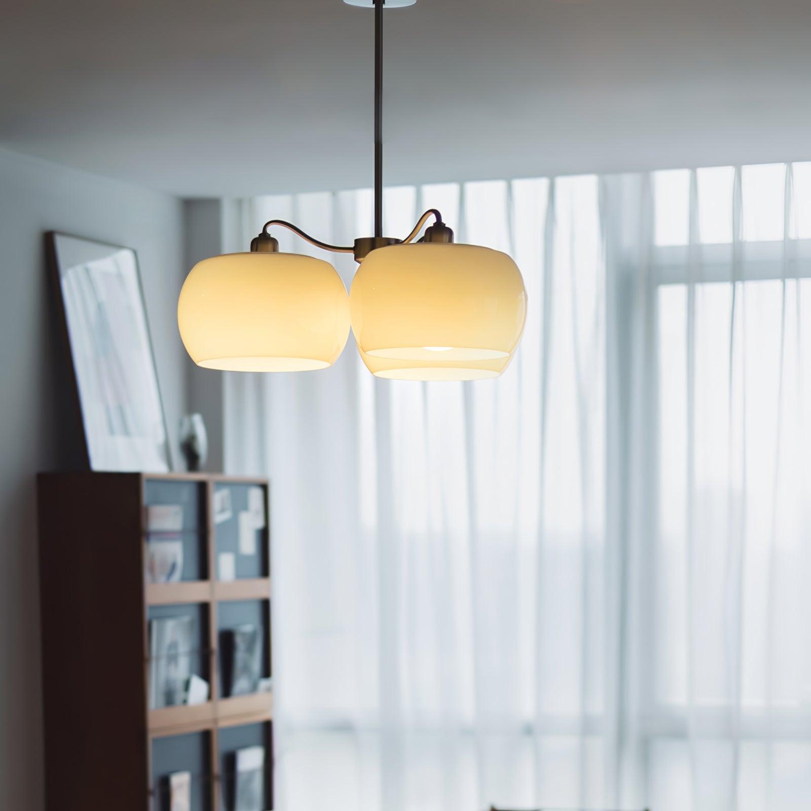 Persimmon chandelier with white glass shades and curved nickel-tone arms