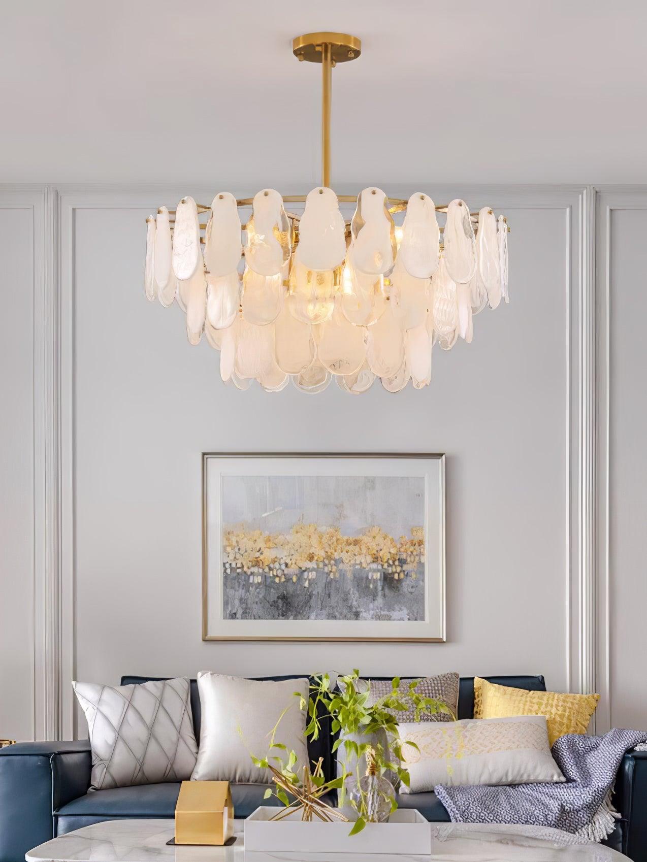Round Cloud pendant hanging above a grey sofa with yellow cushions and framed artwork