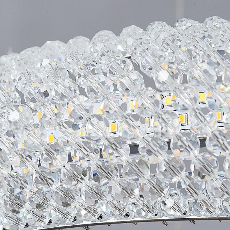 Macro of clear faceted crystal bead rows with yellow LED chips visible on the strip behind them
