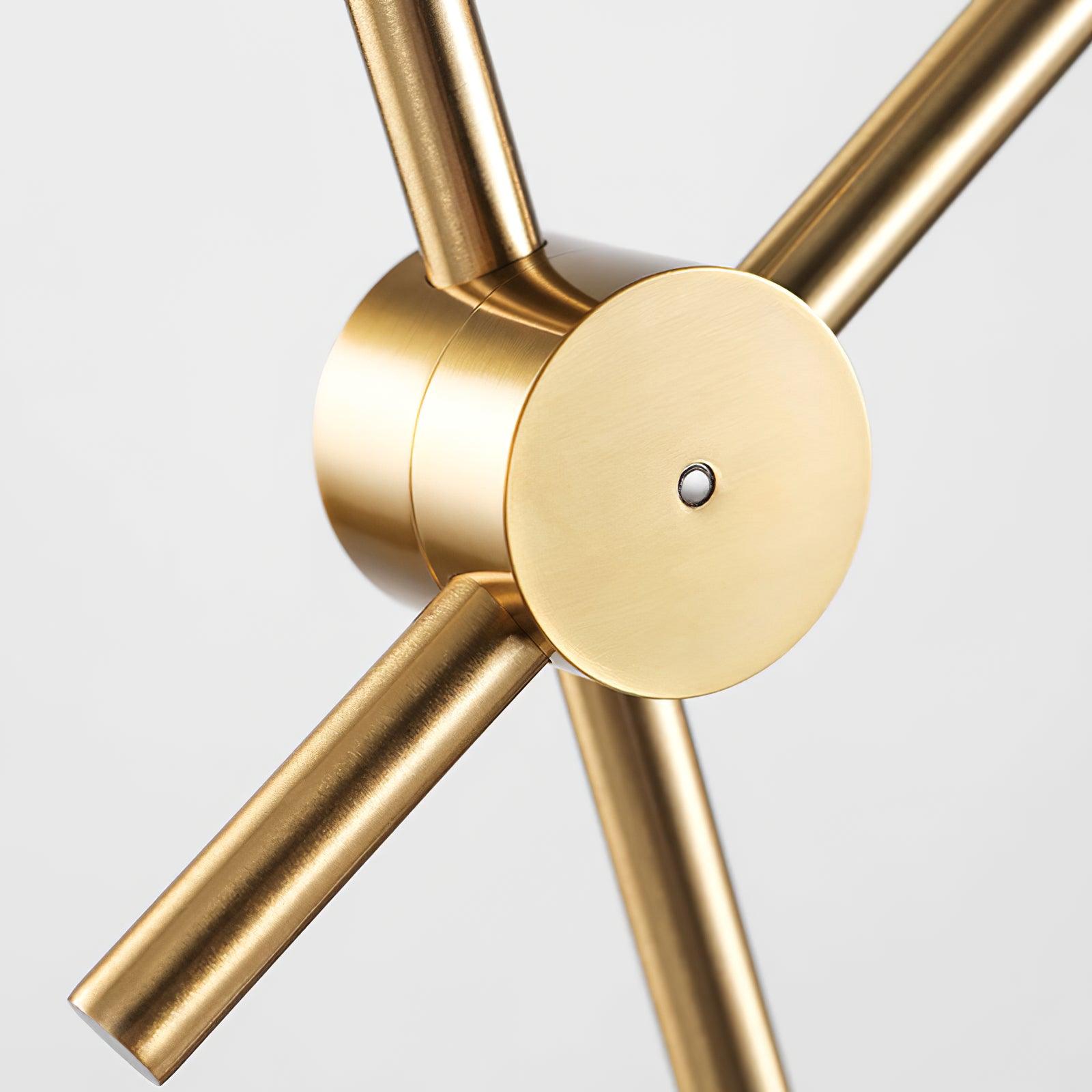 Macro detail of Kemi’s brushed gold round joint, central silver-coloured fastener and crossing cylindrical rods