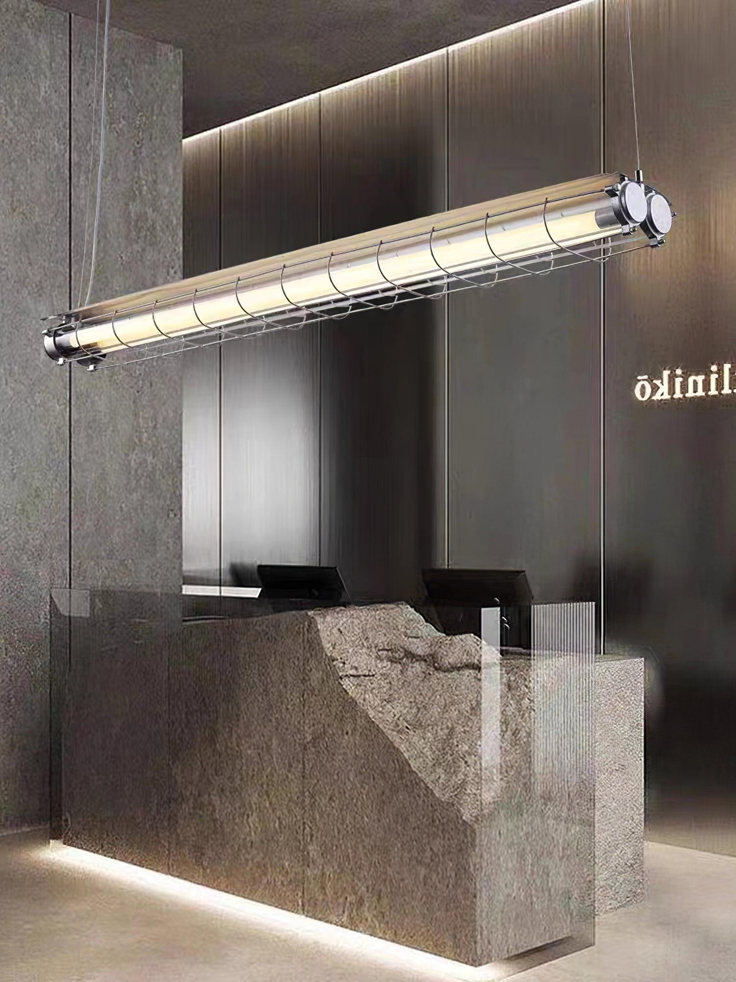 Silver-tone Artisan Glass chandelier above a stone counter in a dark interior