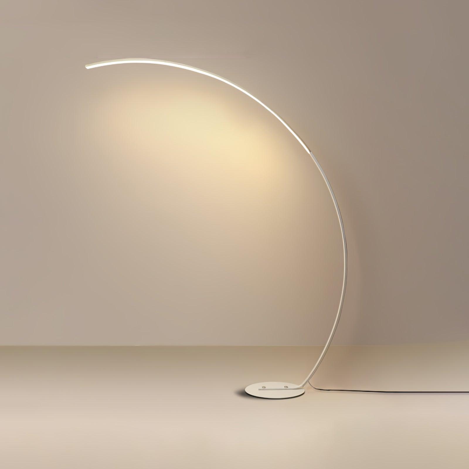 Full White Arc floor lamp on plain beige background, with illuminated upper curve, low base and trailing cable