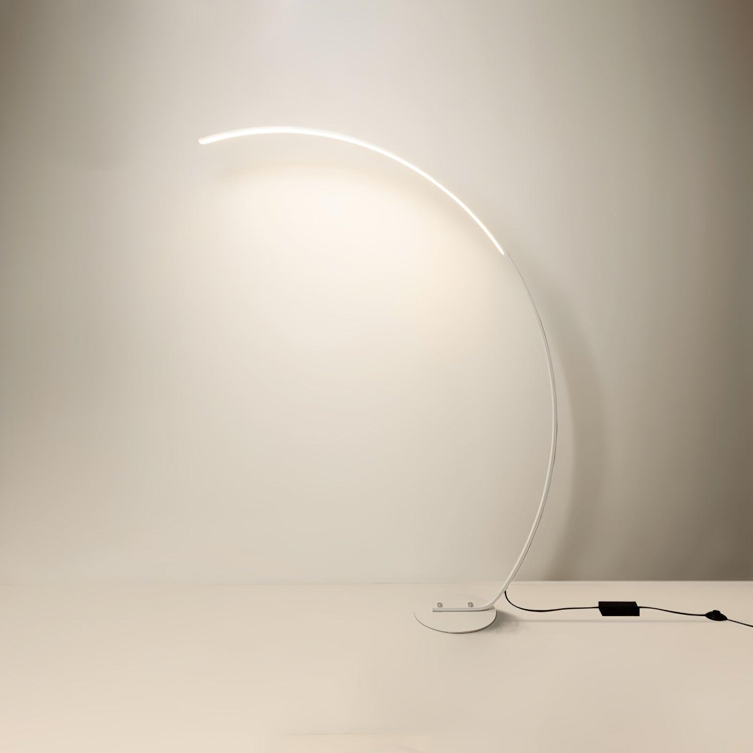 White version of Arc floor lamp with low base, black rectangular cable box and round switch, on plain background