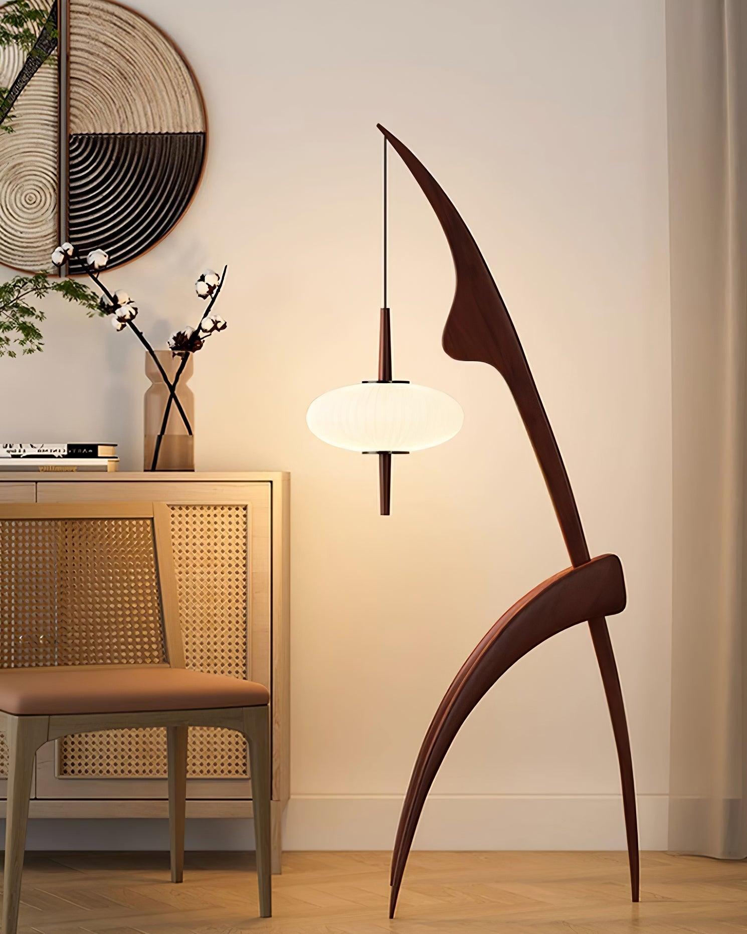 Walnut-colour Mantis lamp with white ribbed shade beside a cabinet