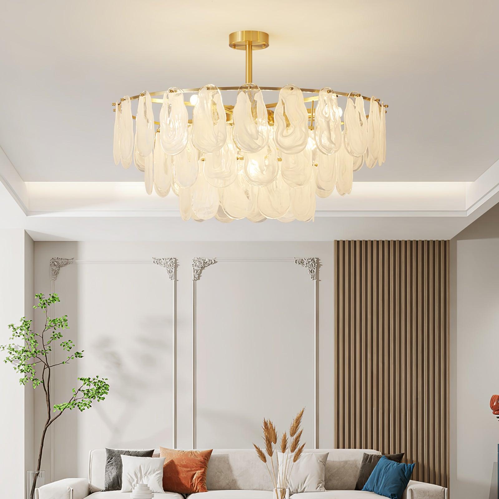 Round Cloud glass pendant above a curved sofa and round coffee table in a light living room