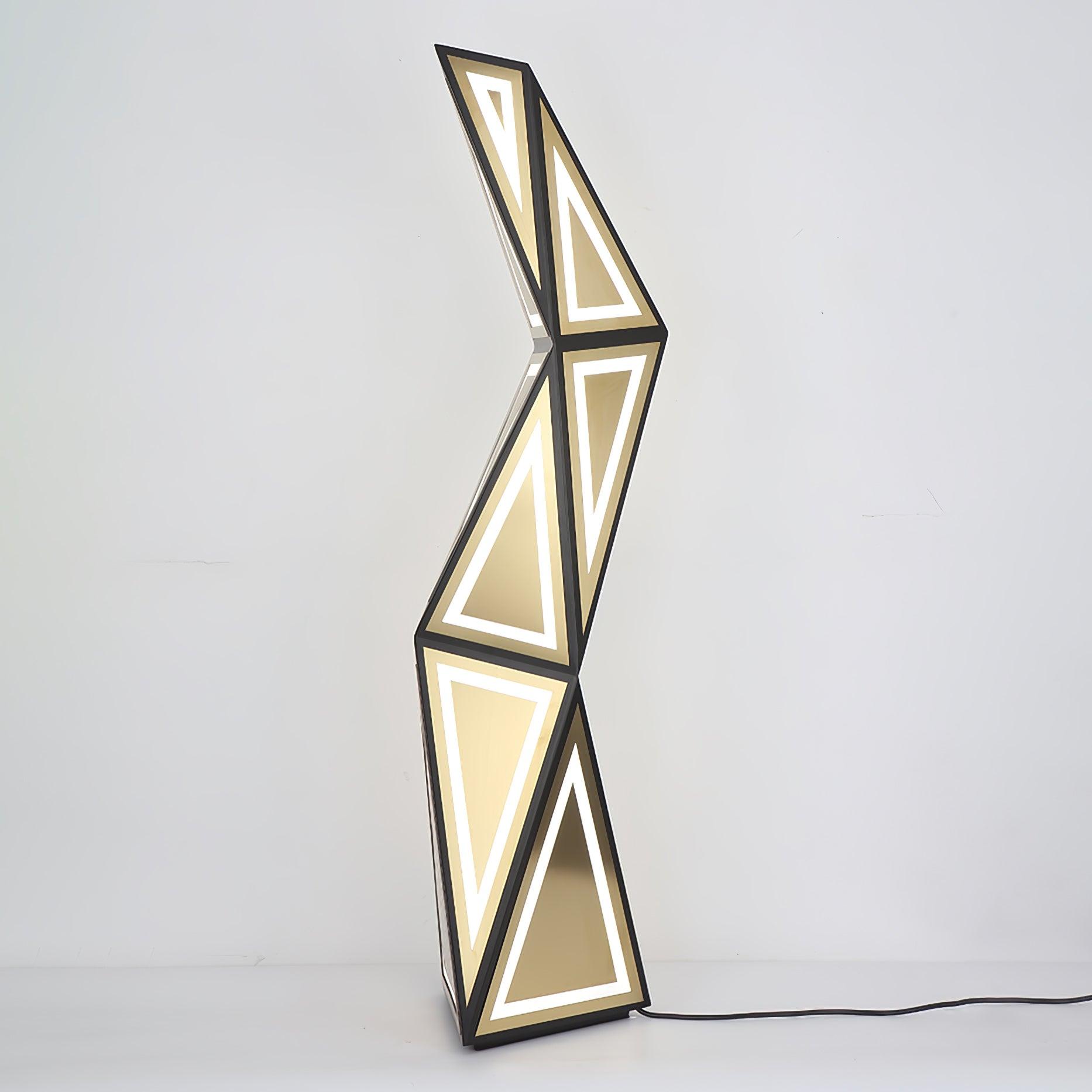 Full lit angular floor lamp from a nearby angle, with gold faces and black lead to the right