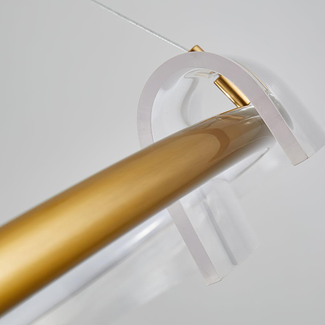 Close view of a clear curved element and gold-coloured rail