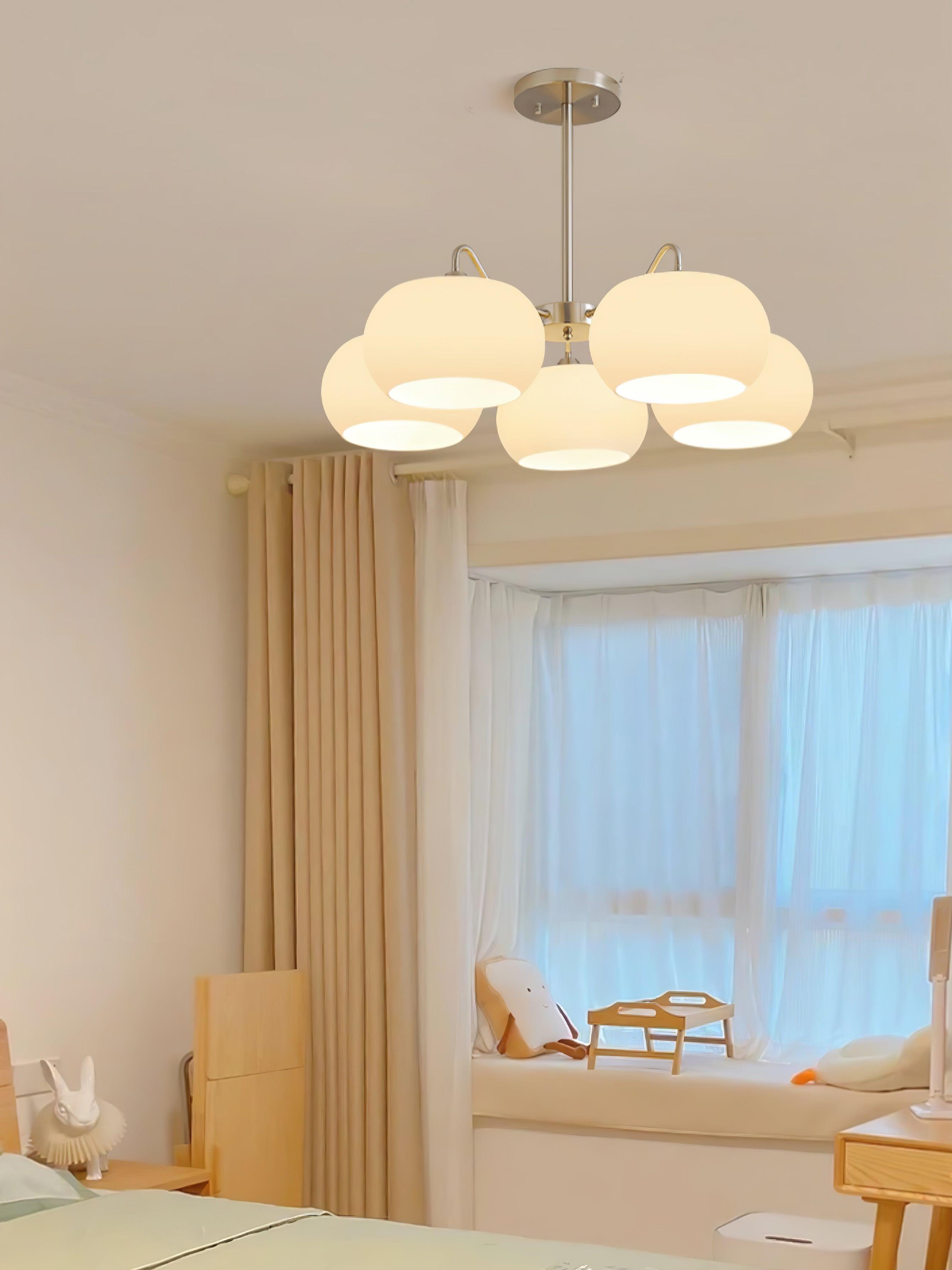 Persimmon chandelier with white glass shades and curved nickel-tone arms