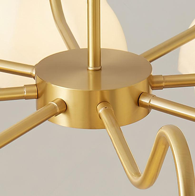 Close view of brass chandelier hub and curved arms