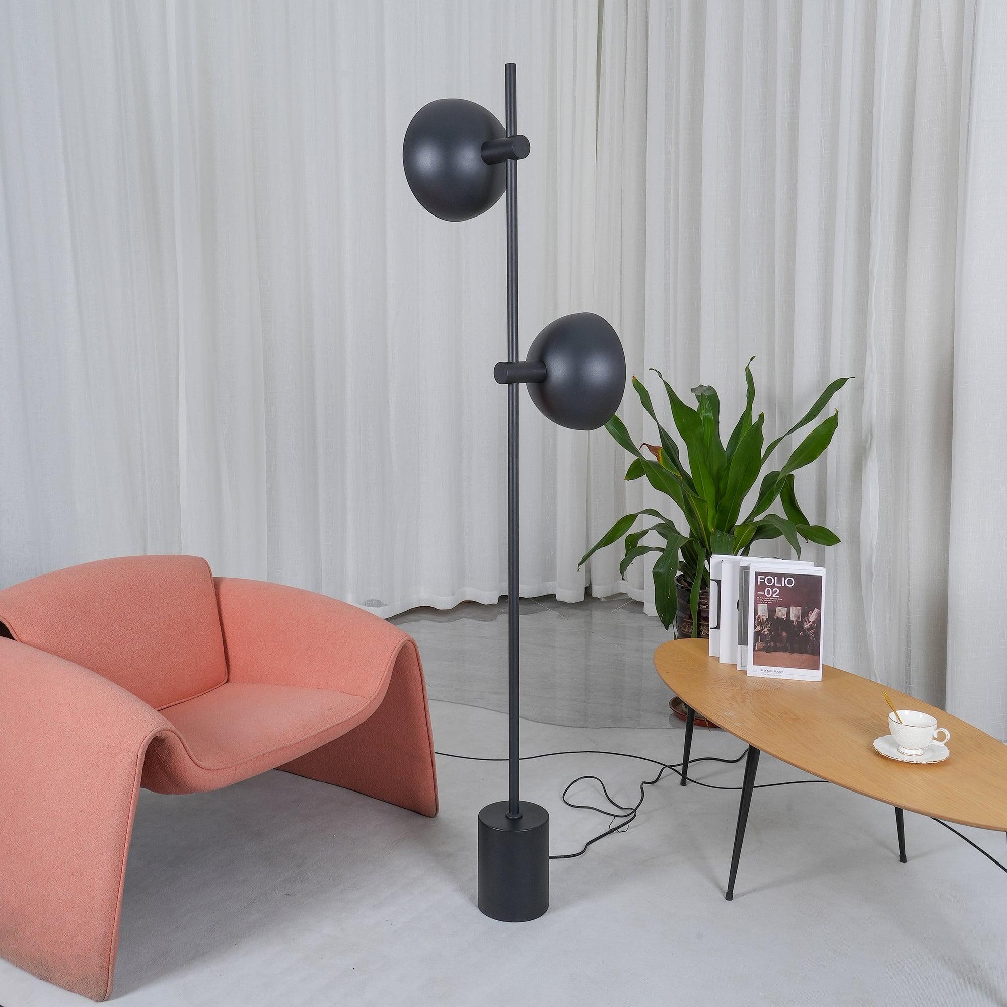 Rear view of Studio floor lamp showing the curved backs of both black heads.