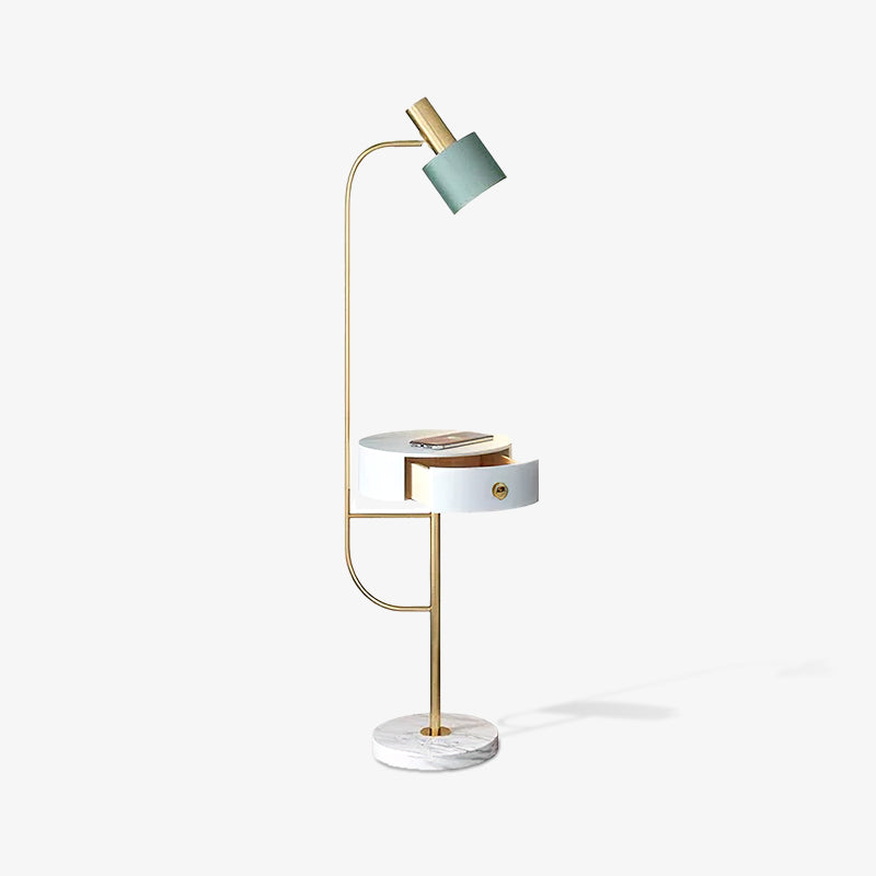 Full gold lamp on white facing left, green shade, white table with open drawer and phone, white veined base and floor shadow