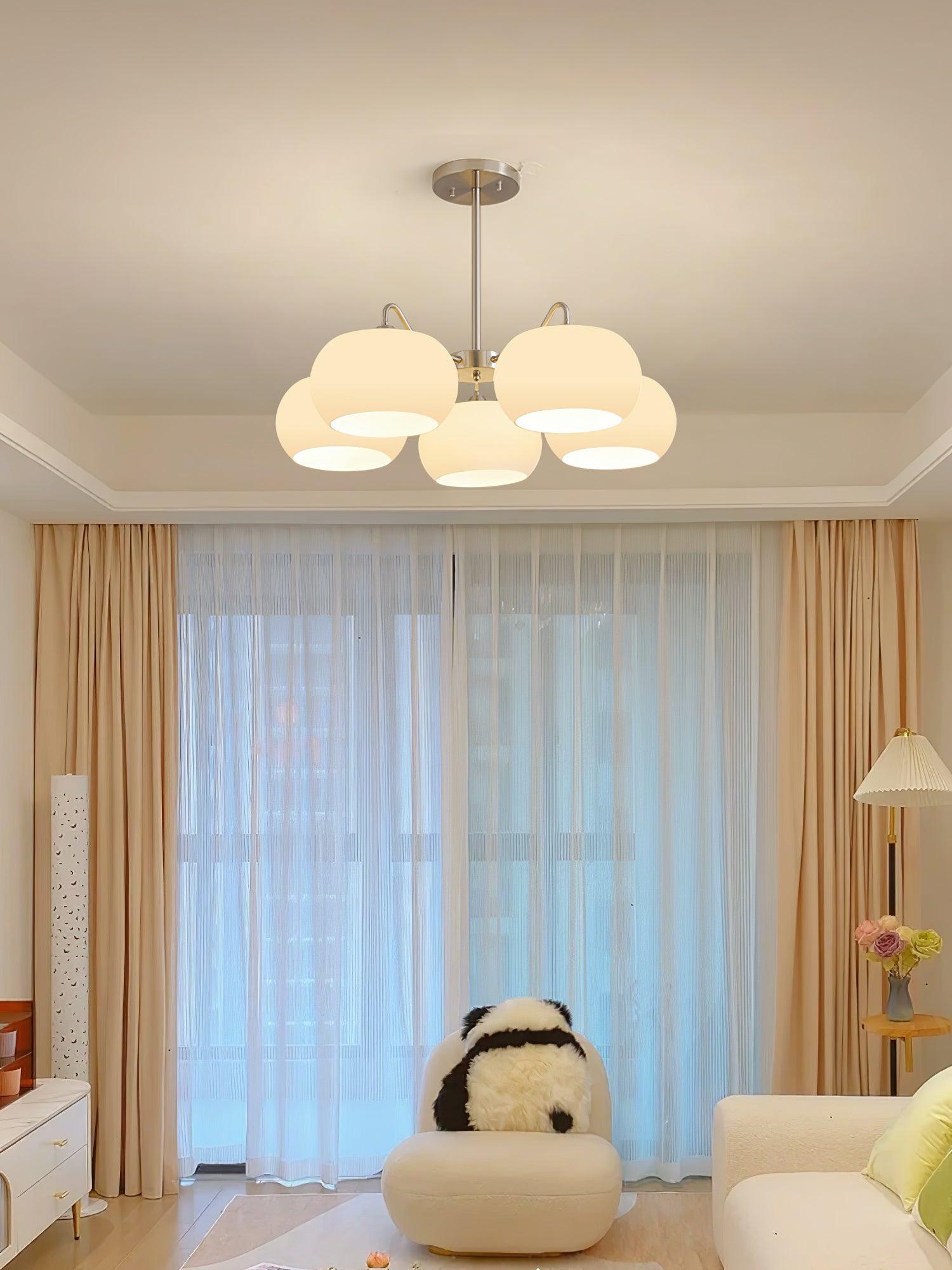 Persimmon chandelier with white glass shades and curved nickel-tone arms