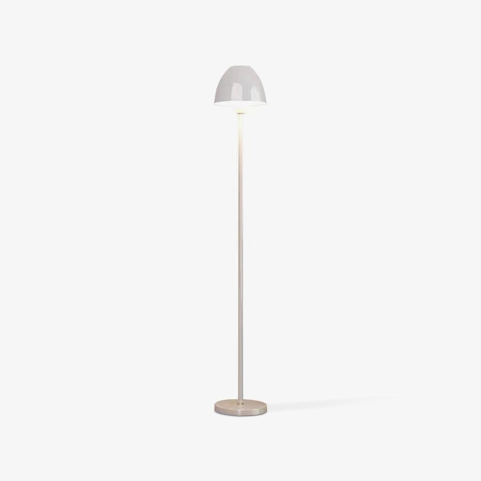 Centered white floor lamp with a rounded shade, straight slender stem and circular base on a pale background