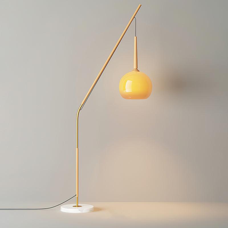 Natural wood-colour Hulusi option with the orange shade hanging right of an angled arm and black cable beside a marble base